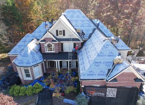 Overhead image of a residential roof in Alpharetta Georgia being repaired after storm damages