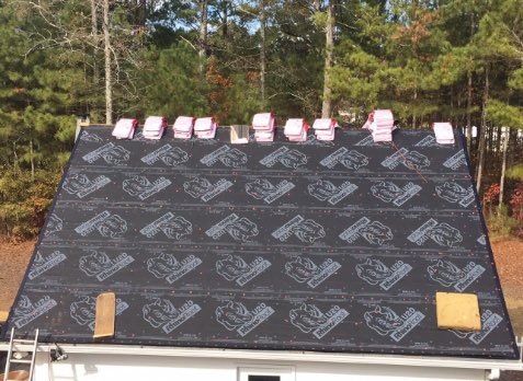 Overhead image of a residential roof in Alpharetta Georgia being repaired after storm damages