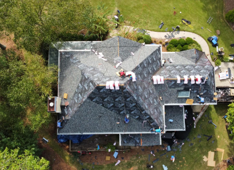 Overhead image of a residential roof in Alpharetta Georgia being repaired after storm damages