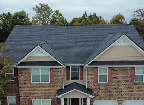 Image of a brick house with newly replaced gray shingled roof in Bremen Georgia