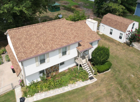 Image of a white house with newly installed brown shingled roof in Bremen Georgia