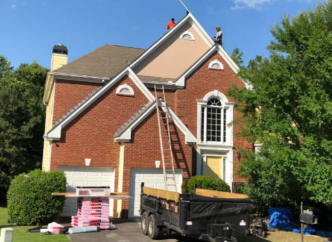 Image of roofers on a roof repairing damaged shingles in Bremen