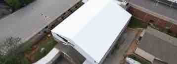 overhead image of a white coating on a commercial roof