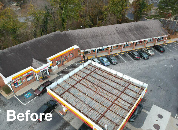 Photo of a shopping center with a brown asphalt roof before roof replacement