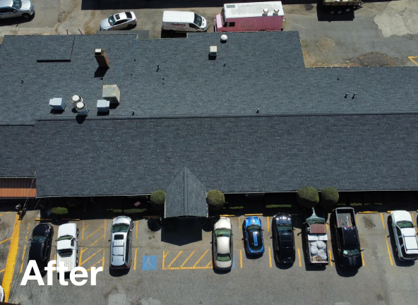 Photo of a large gray asphalt commercial roof after roof replacement