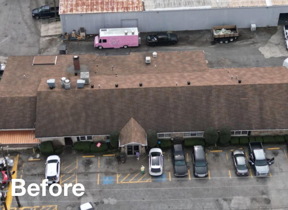 Photo of a large brown asphalt commercial roof before roof replacement