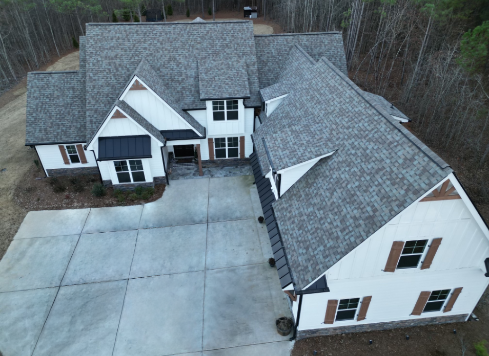 Image of a white house with newly replaced gray shingled roof in Douglasville Georgia