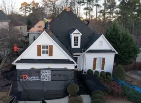 Image of a white house with newly replaced gray shingled roof in Douglasville Georgia