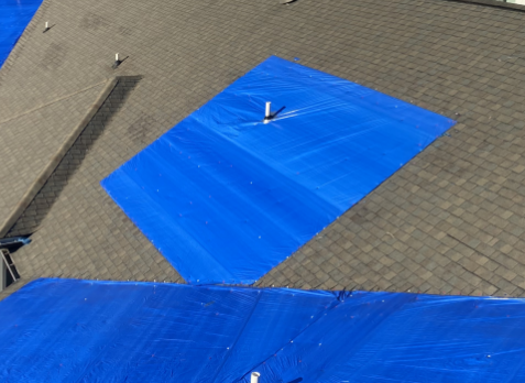 Images of tarps covering shingles on a roof