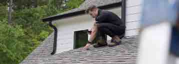 Roofer inspecting a roof