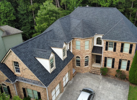 Image of a brick house with newly installed gray shingled roof in Nashville Tennessee