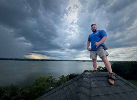 Image of Whitaker Roofing contractor on top of a roof during a roof inspection