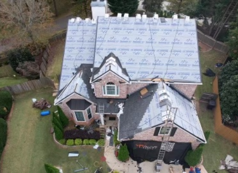 Photo of a Nashville brick home having its roof repaired after storm damage