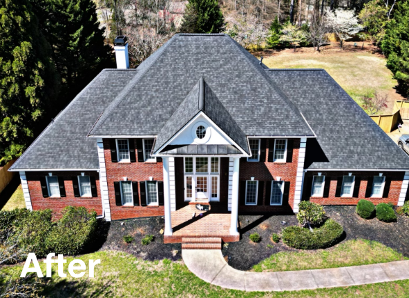 Photo of a gray asphalt residential roof on a brick house after roof replacement