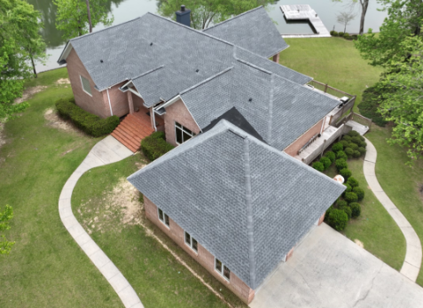 Aerial image of a residential house with newly installed gray shingled roof in Birmingham Alabama