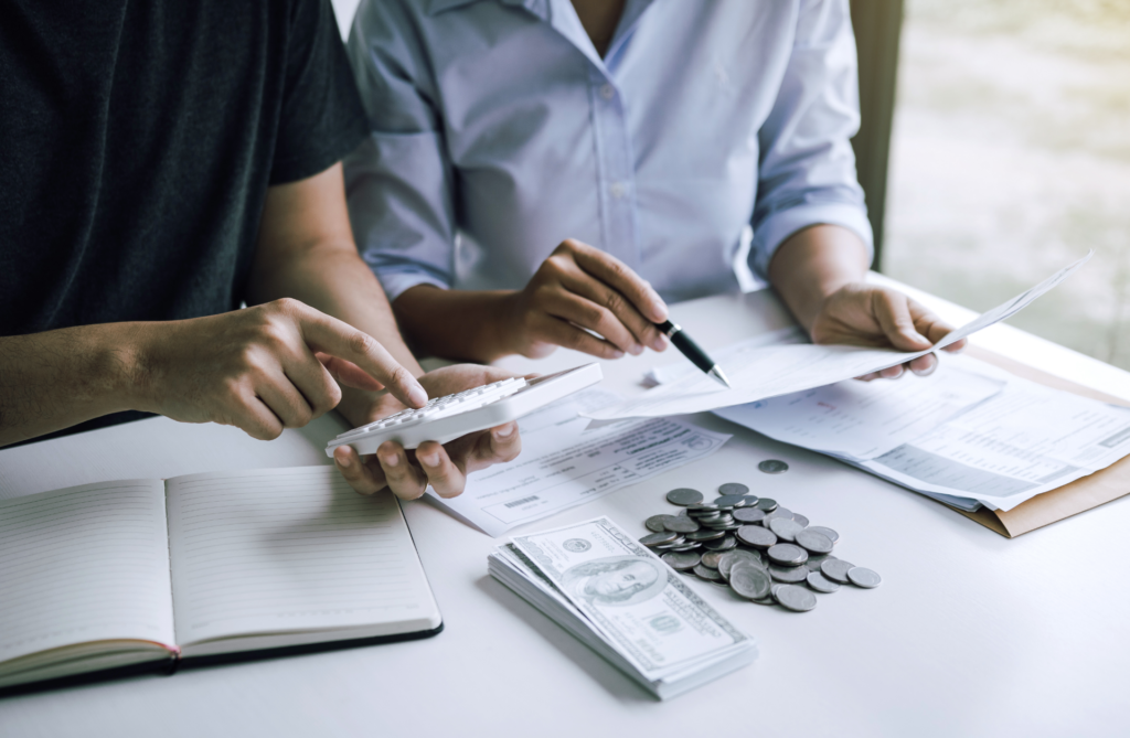 Image of two people at a desk going over roof finance options