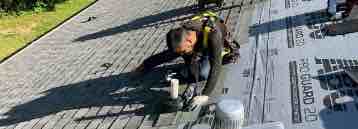 image of a Roofer replacing a residential roof