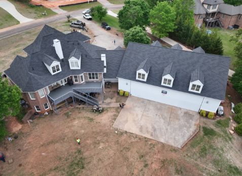 Image of a brick house with newly installed gray shingled roof in Birmingham Alabama