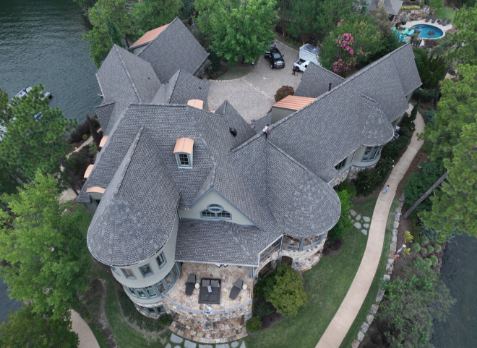 Image of a brick house with newly replaced gray shingled roof in Birmingham Alabama