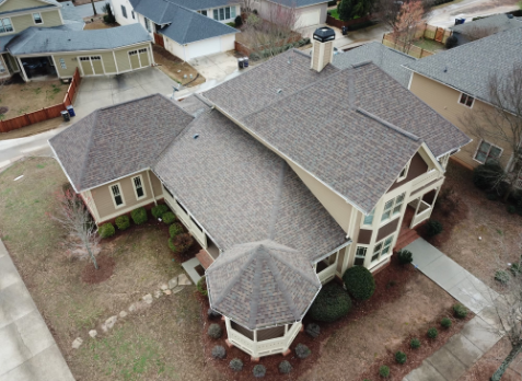 Cumming roofing Image of a house with newly installed dark gray shingled roof