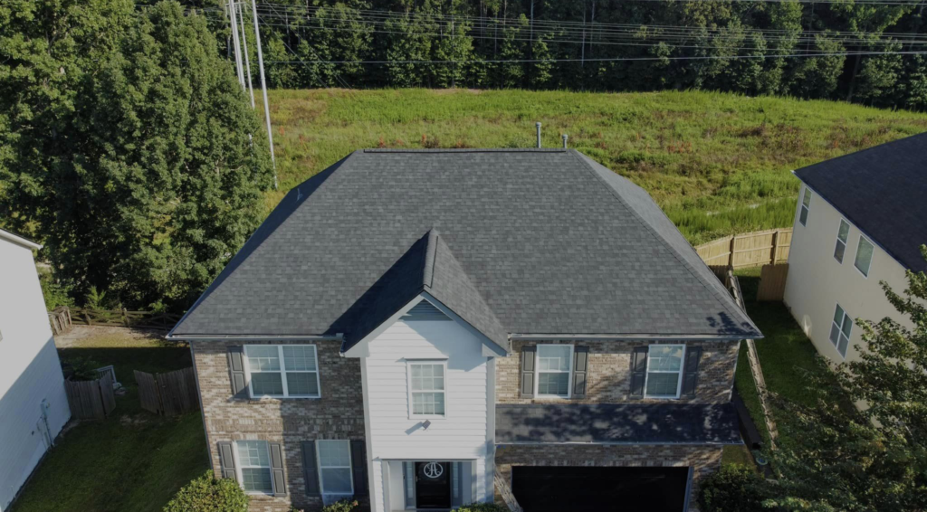 Photo of brick house with new gray shingled roof