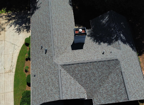 Image of roof with newly repaired gray shingles