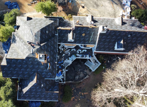 Overhead image of a residential roof in Roswell Georgia being repaired after storm damages