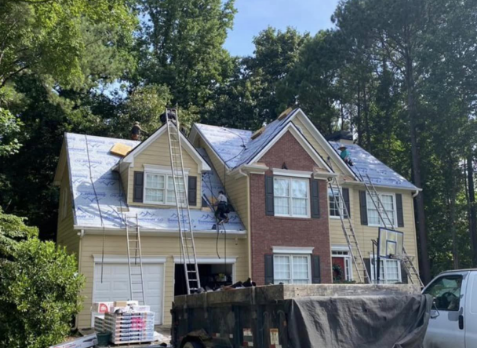 Image of a residential roof in Roswell Georgia being repaired after storm damages