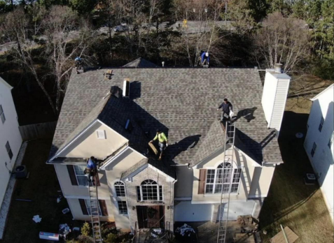 Image of roofers on a roof repairing damaged shingles in Trussville