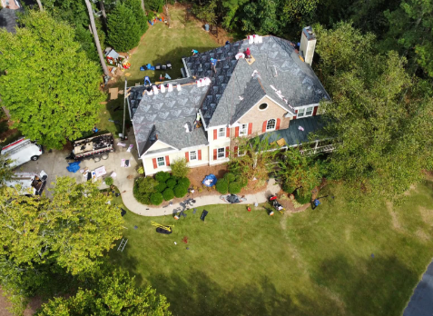 Overhead image of a residential roof in Trussville Alabama being repaired after storm damages