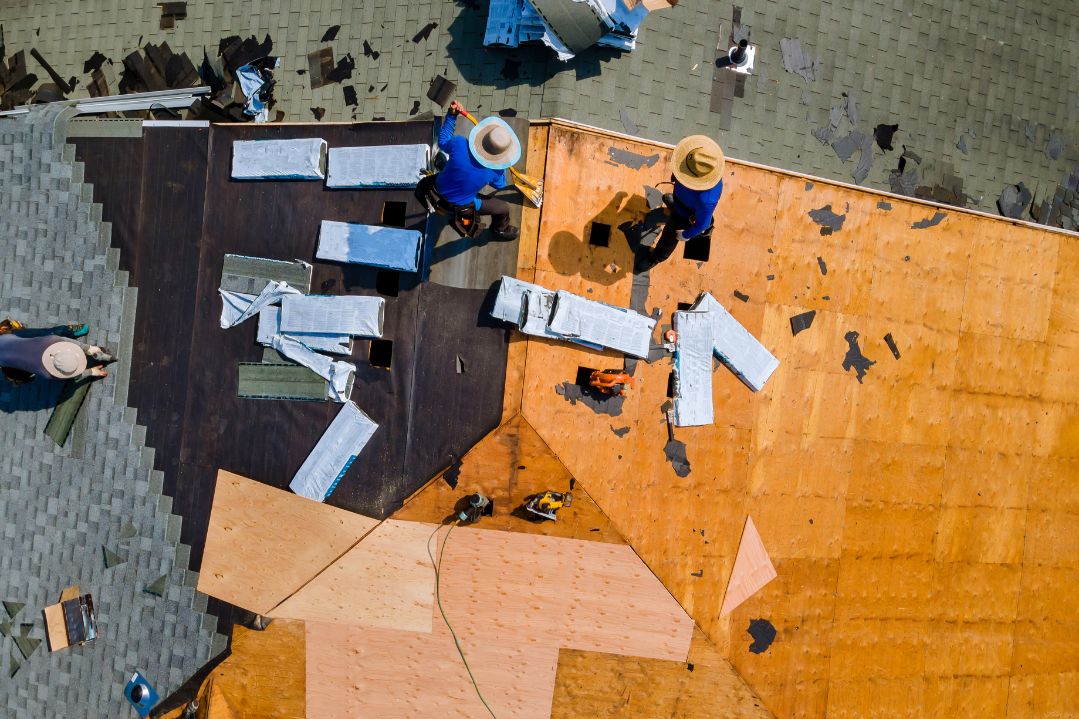 Shingled roof being replaced by insurance claim roofers