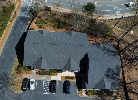 Newly installed gray asphalt shingled commercial roof