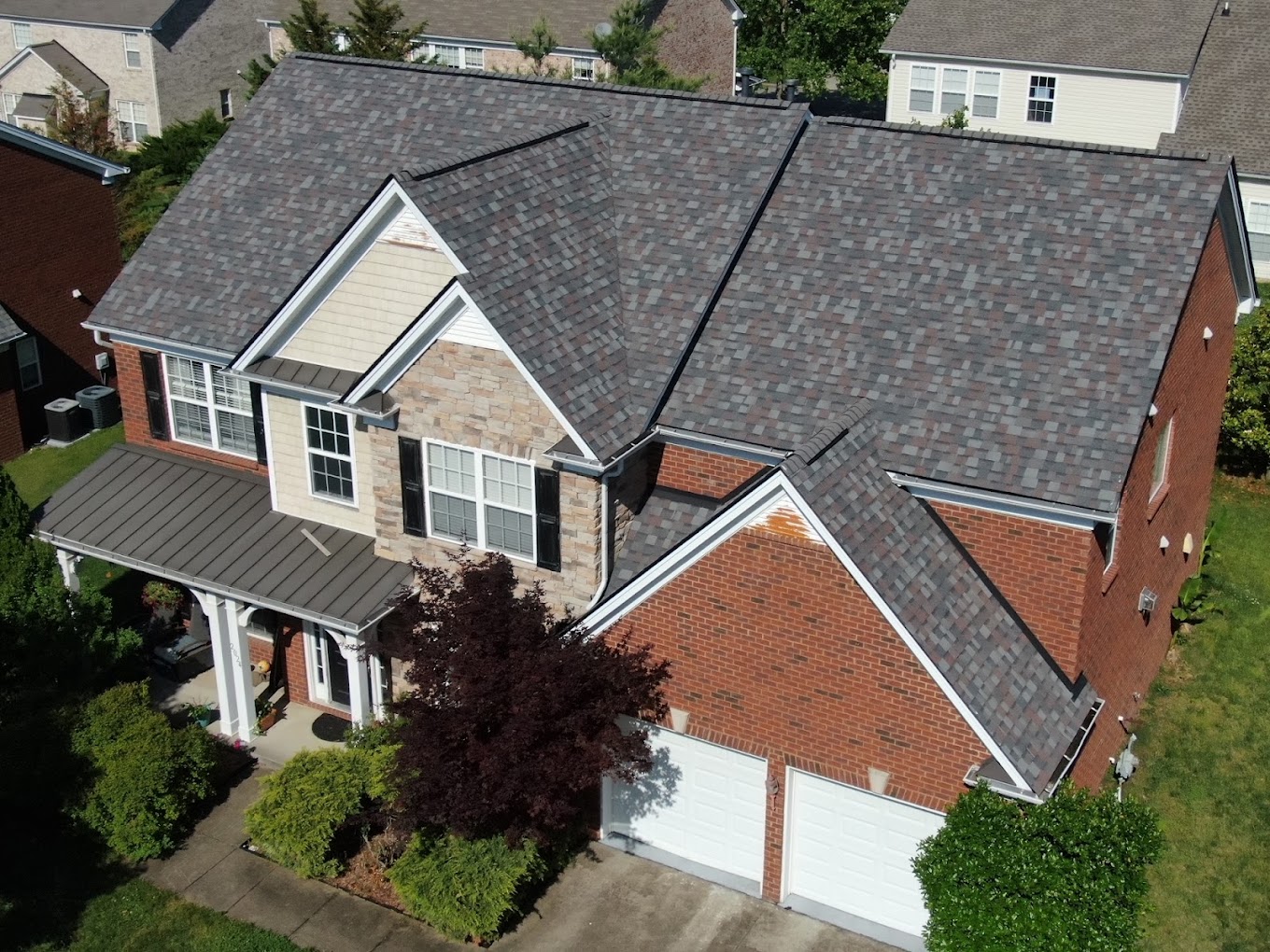 Franklin roofing Image of a brick house with newly installed gray shingled roof