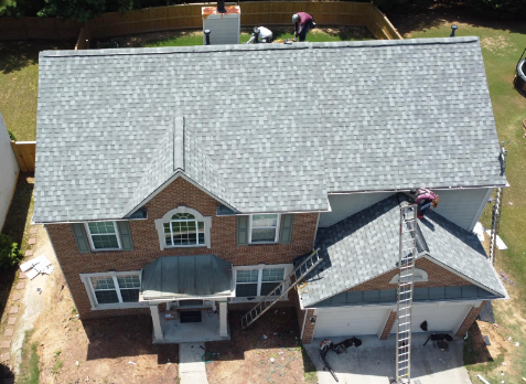 Image of roofers on a roof repairing damaged shingles in Augusta