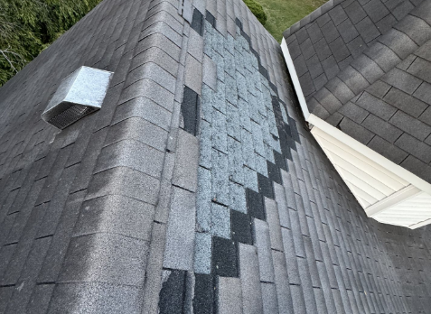 home with gray shingles needing roof repair