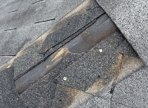 Roof repair needed after some damaged shingles on a house in Douglas