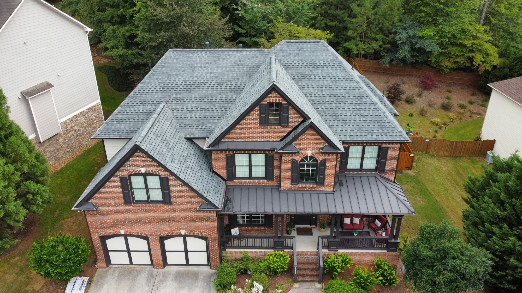 Overhead Image of gray shingle roofing on a brick house