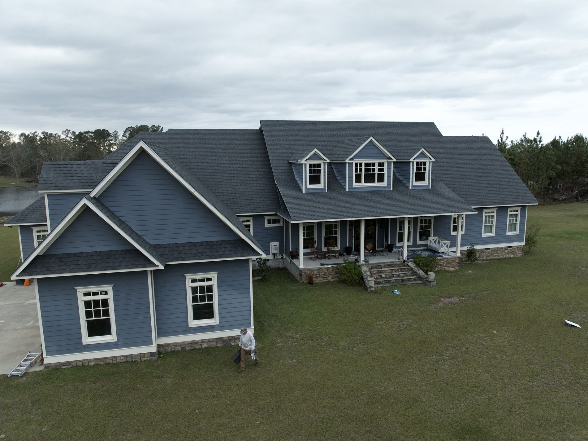 Evans roofing Image of a house with newly installed gray shingled roof