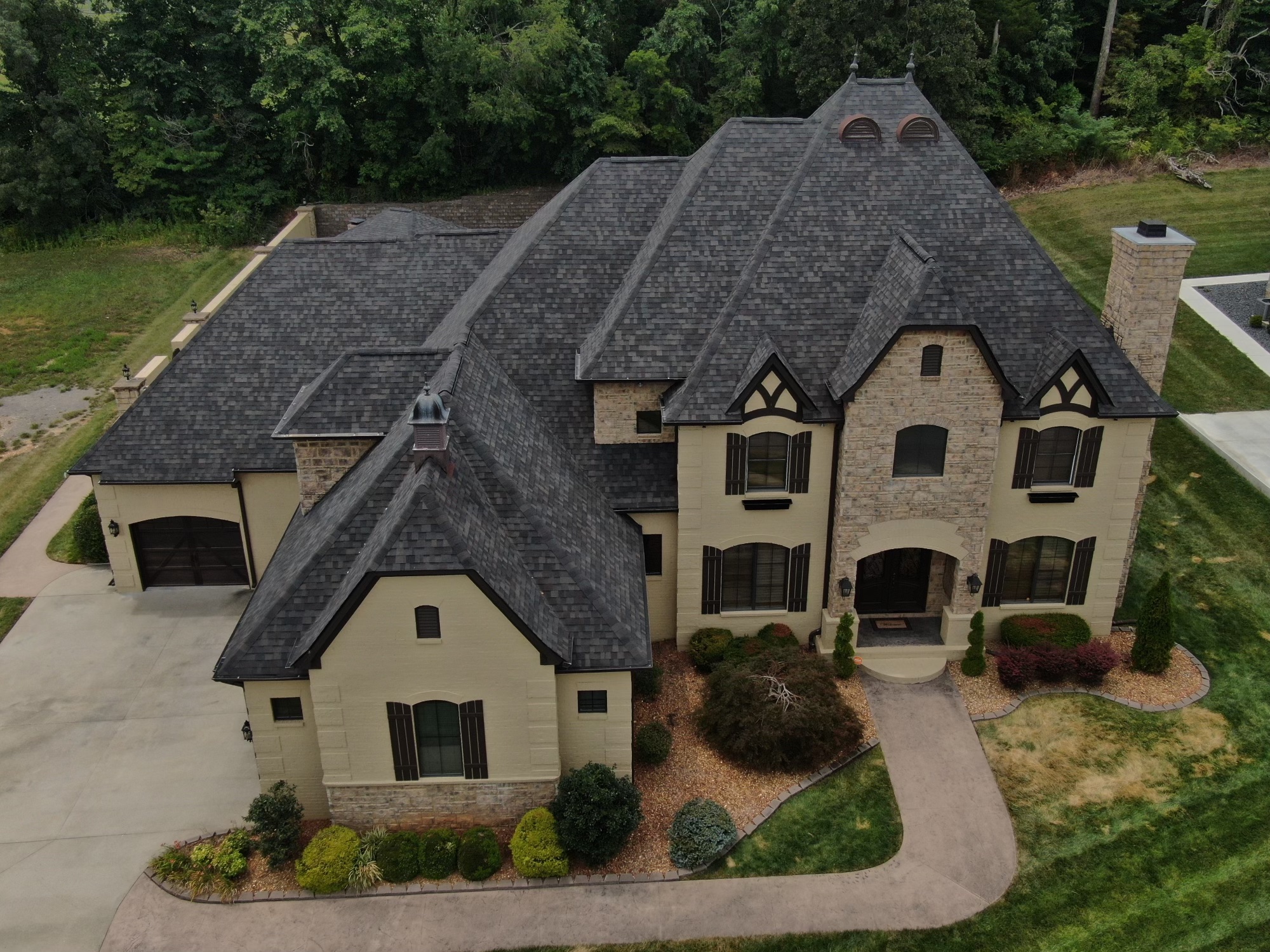 Overhead Image of gray shingle roofing on large house