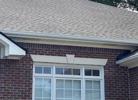 Up close image of a new gutter installed on a brick house