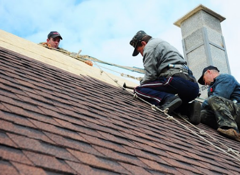 image of Roofers replacing a residential roof