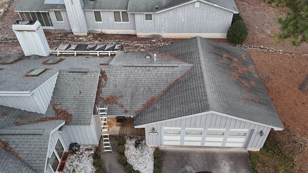 Overhead Image of a gray residential shingle roof during roof maintenance