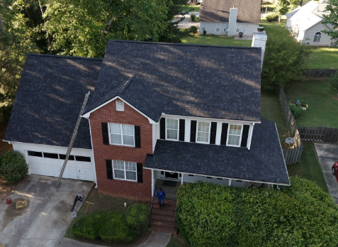 Image of brick residential house with a new shingle roof in Fayetteville