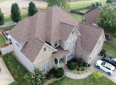 Image of brick residential house with a new shingle roof in Hendersonville