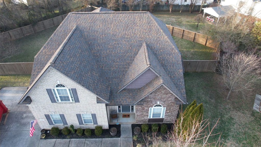 Image of a brick house with newly installed gray shingled roof in Nashville Tennessee