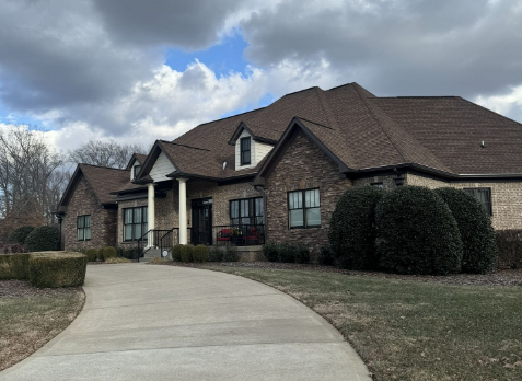 Image of residential house with a new brown shingle roof