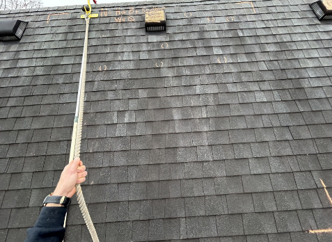 First person point of view of a roofer climbing a roof during a roof inspection.