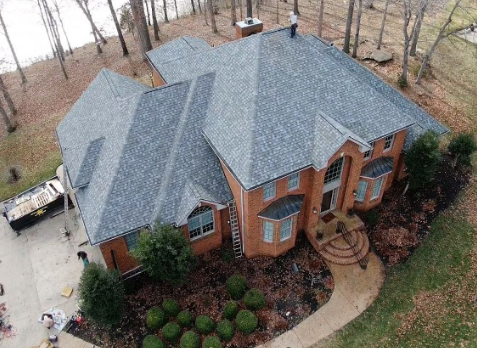 Image of a brick house after a roof replacement