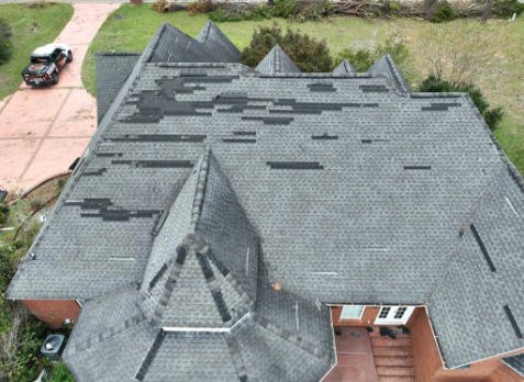 Image of a residential roof in Pell City with storm damages