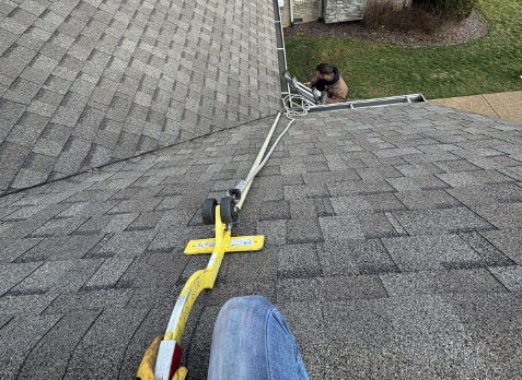 First person point of view of a roofer on a roof during a roof inspection in Powder Springs.